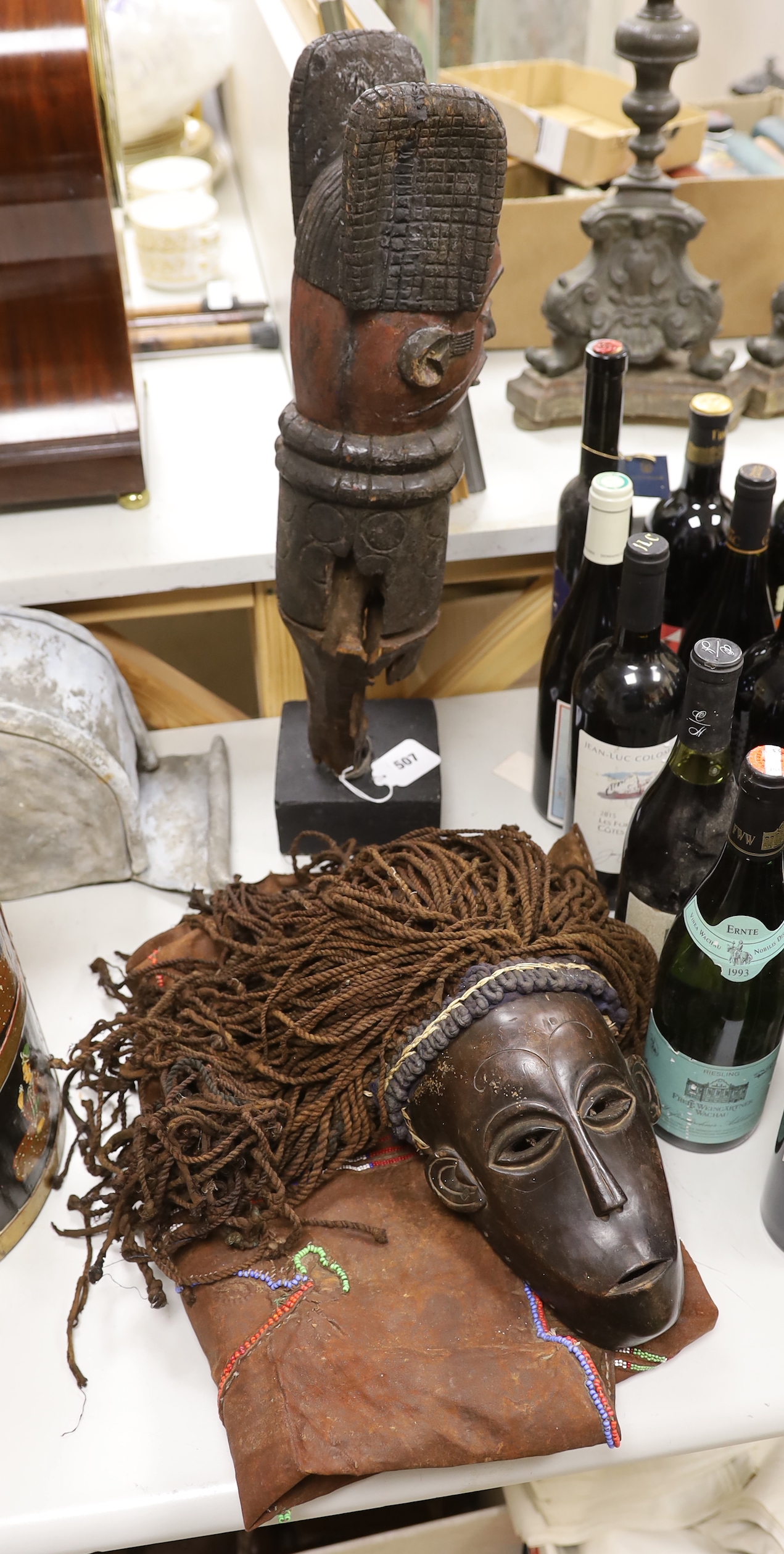 A Massai apron, dan mask and an African carving